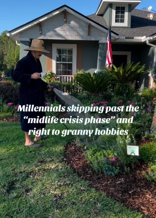 The meme is a humorous image of a person in their 40s or 50s, dressed in a bathrobe and slippers, watering a garden. The text "Millennials skipping past the 'midlife crisis phase' and right to granny hobbies" is overlaid on the image, suggesting that this person has bypassed the traditional midlife crisis and is now embracing the "granny" lifestyle.